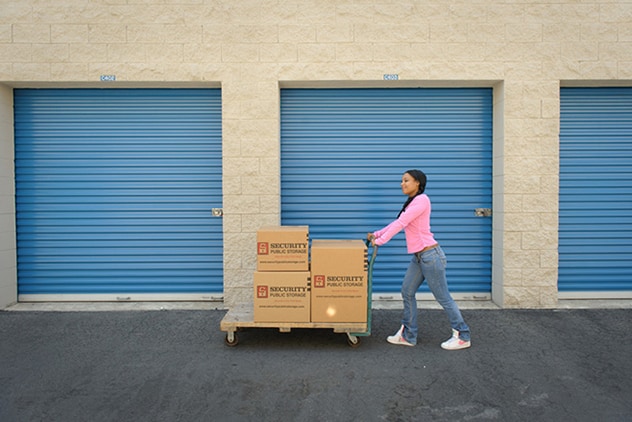 storage customer walking to unit with boxes