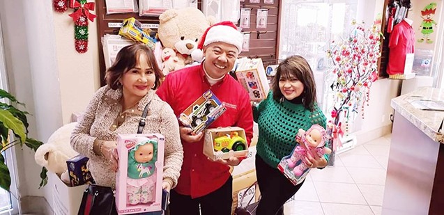 Manager and customers with toy donations