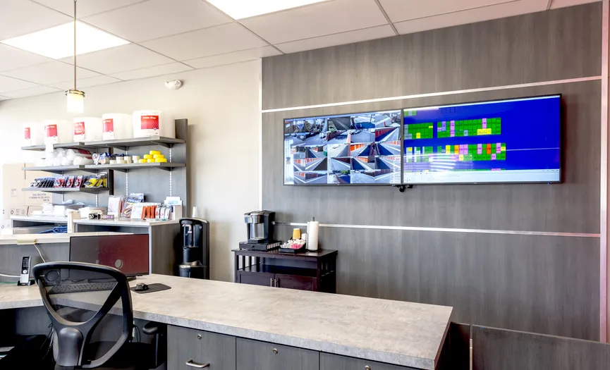 Main office desk and video surveillance screens at Security Public Storage in Sparks