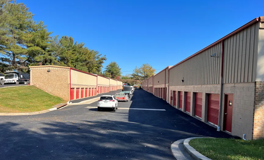 Cars driving past ground floor storage units at a drive-up storage facility in Gaithersburg
