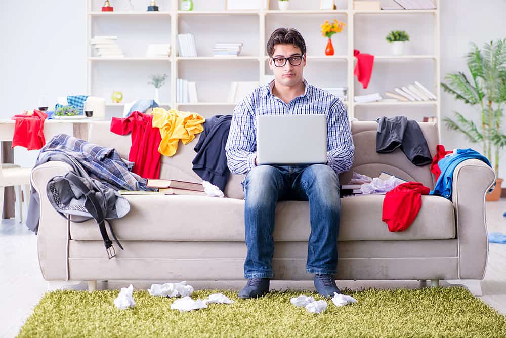 Man sitting in cluttered house