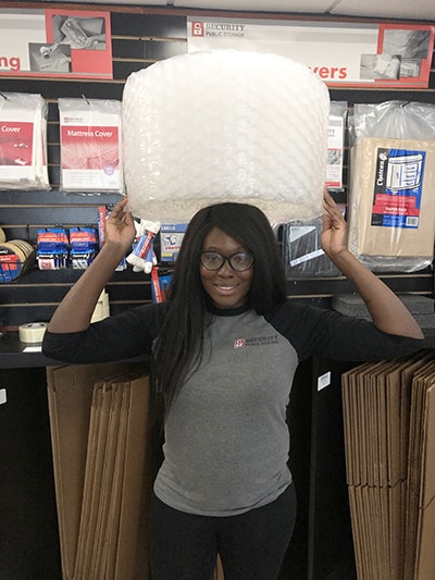 young lady buys bubble wrap at storage facility